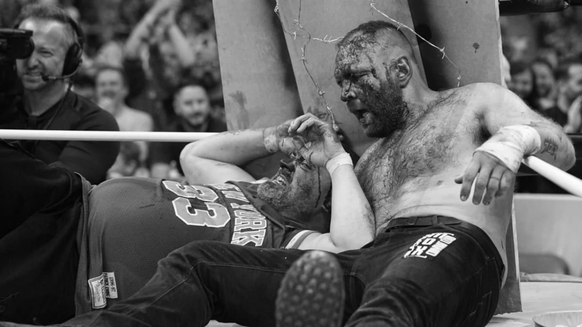 Jon Moxley and Eddie Kingston lying down in a crumpled table at AEW All In 2023