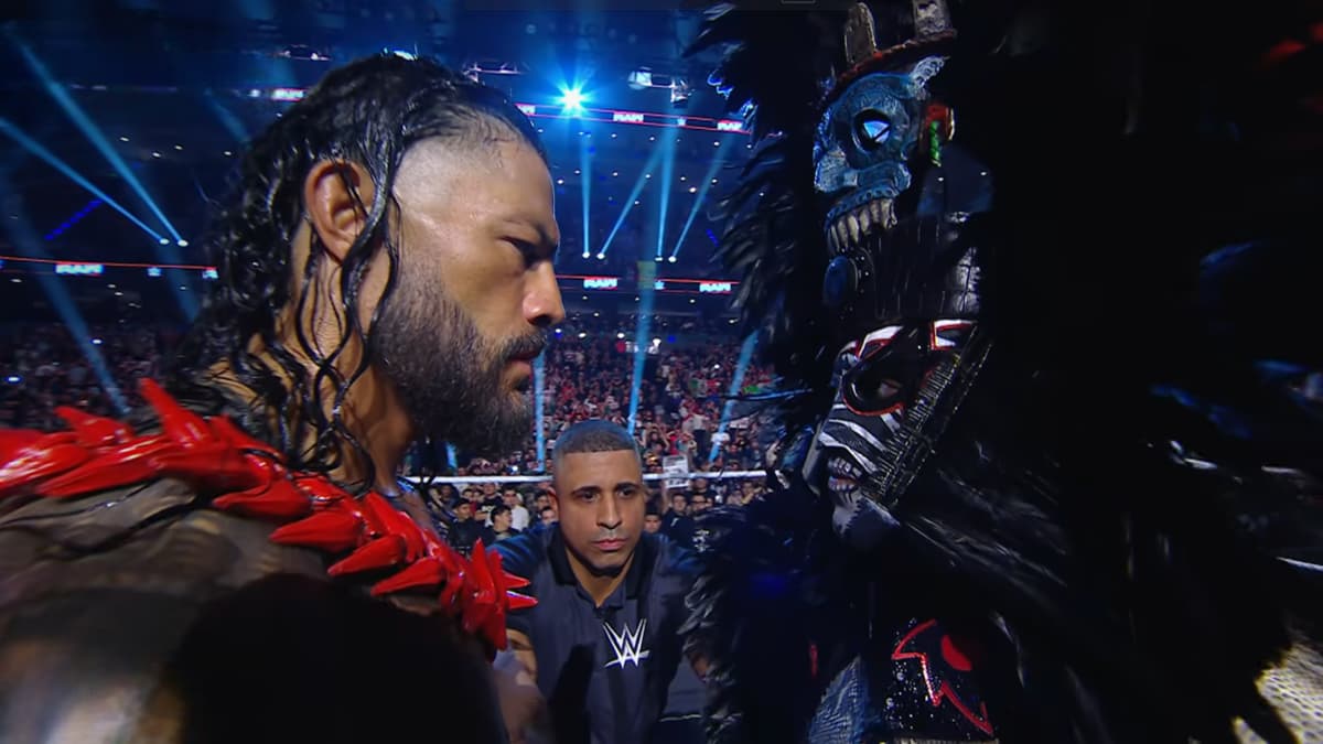 Penta and Roman Reigns staring at each other