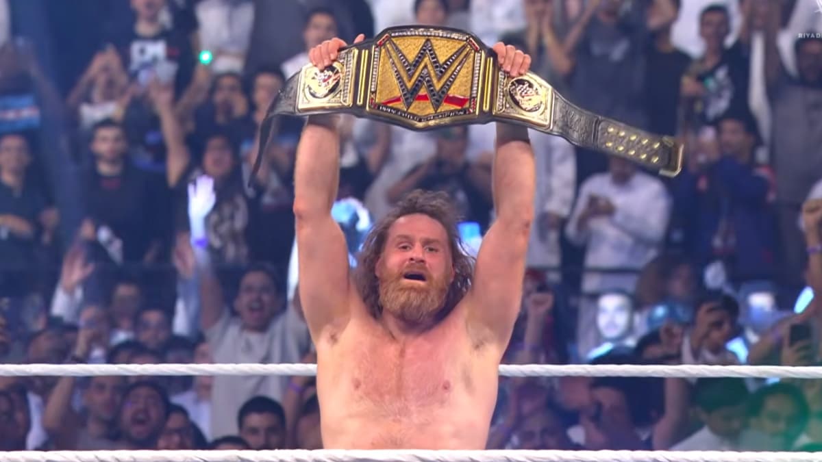 Sami Zayn lifts the WWE Championship