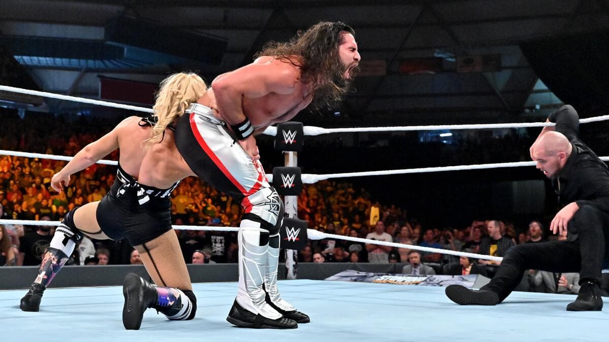 Lacey Evans hitting Seth Rollins with a low blow at WWE Stomping Grounds 2019