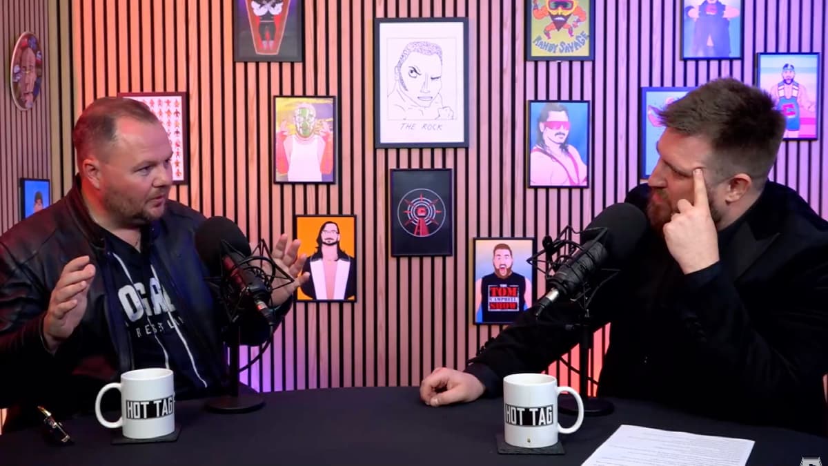Tom Campbell and Lee McAteer chatting while sitting at a desk