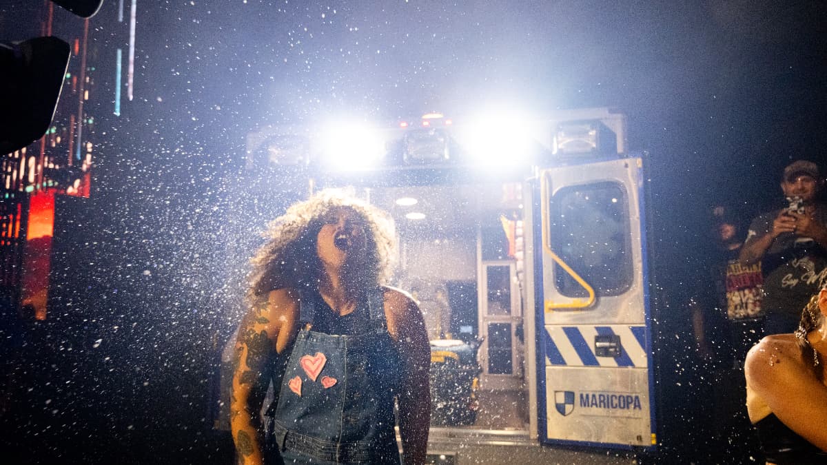 Willow Nightingale with water flying through the air in front of an ambulance at AEW Anarchy in the Arena for Double or Nothing 2025