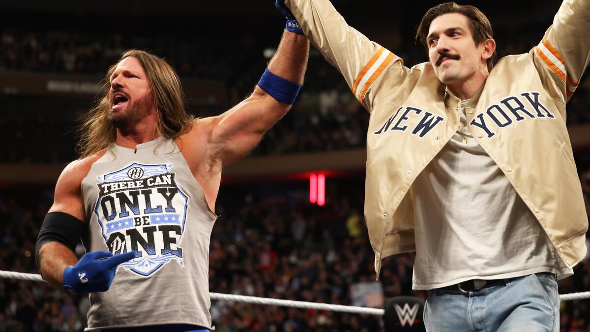AJ Styles raising Andrew Schulz's arm on WWE Raw