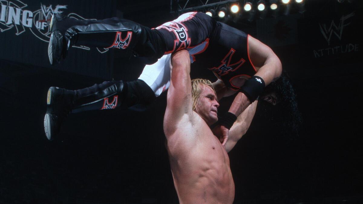 Billy Gunn holding up X-Pac for a press slam at WWE King of the Ring 1999