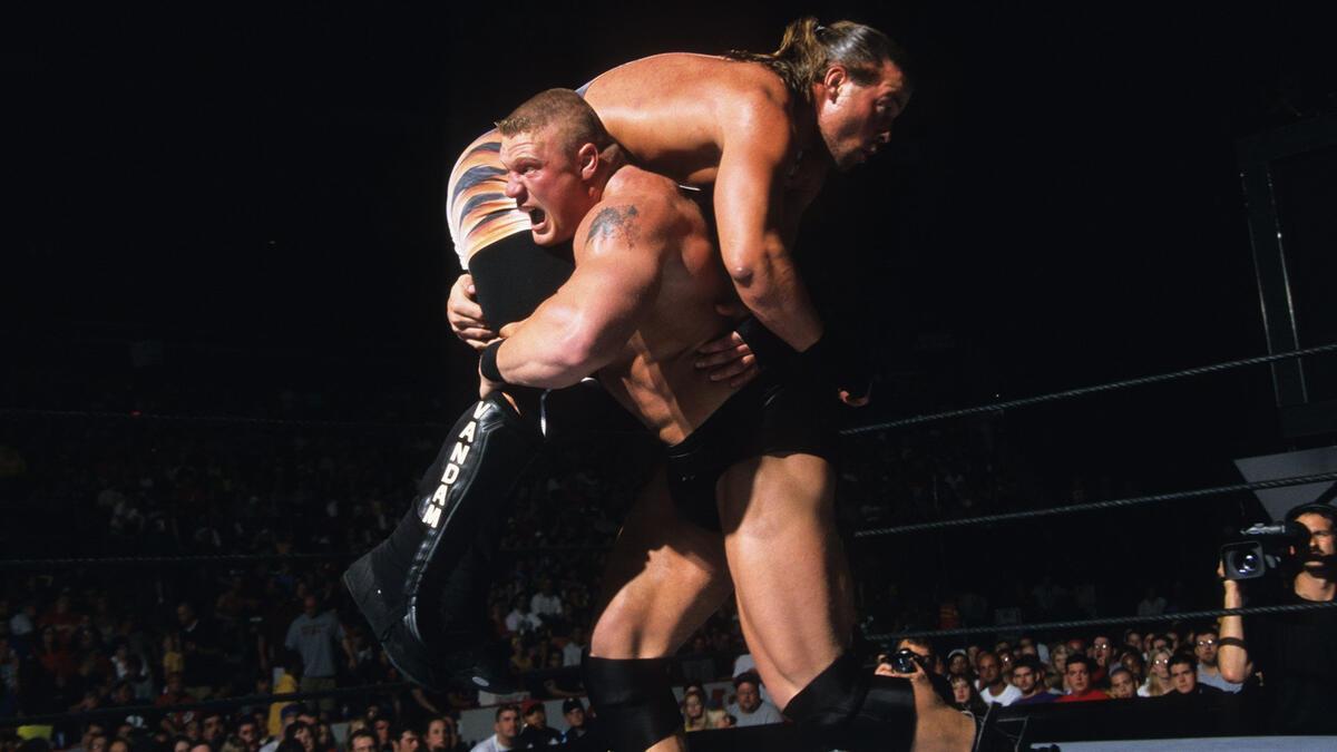 Brock Lesnar running while carrying RVD inside a WWE ring