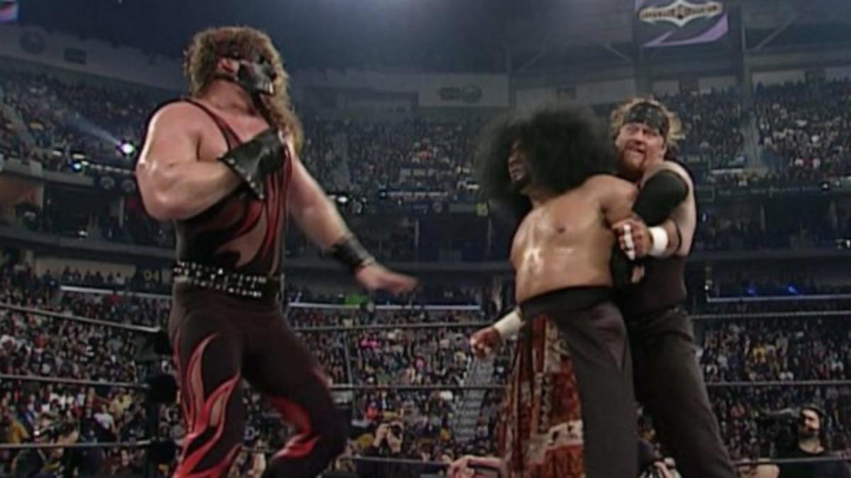 Haku being double teamed by Kane and The Undertaker