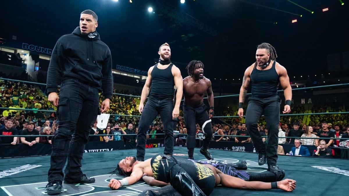 DarkState standingover Leon Slater and Je'Von Evans in the ring at TNA Bound For Glory