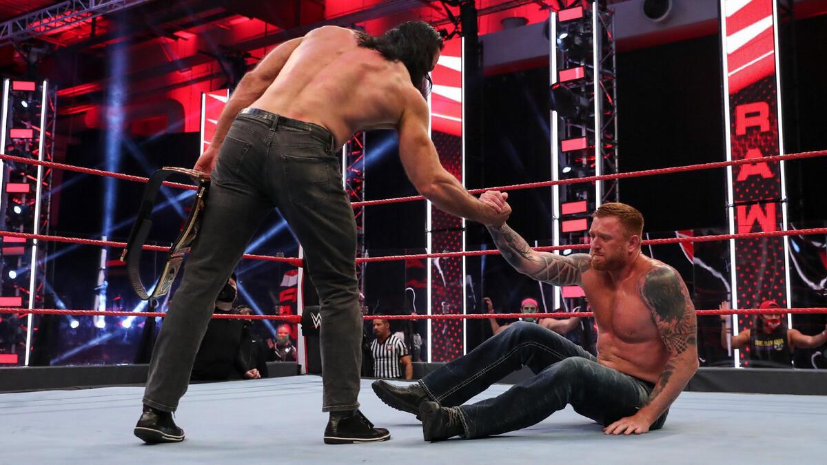 Drew McIntyre pulling up Heath Slater on WWE Raw