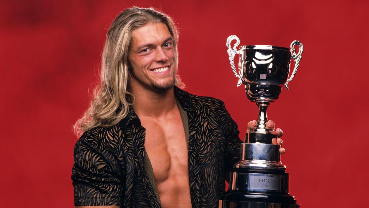 Edge smiling while holding the 2002 King of the Ring trophy