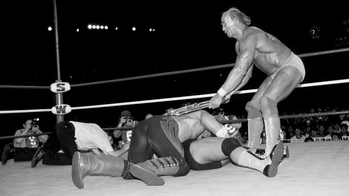 Hulk Hogan hitting a member of the Road Warriors with a steel chair as they cover Genichiro Tenryu