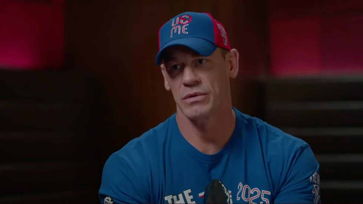 John Cena sitting in a blue cap and blue t-shirt