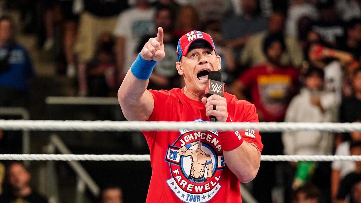 John Cena wearing red gear pointing in a WWE ring at Money in the Bank 2024
