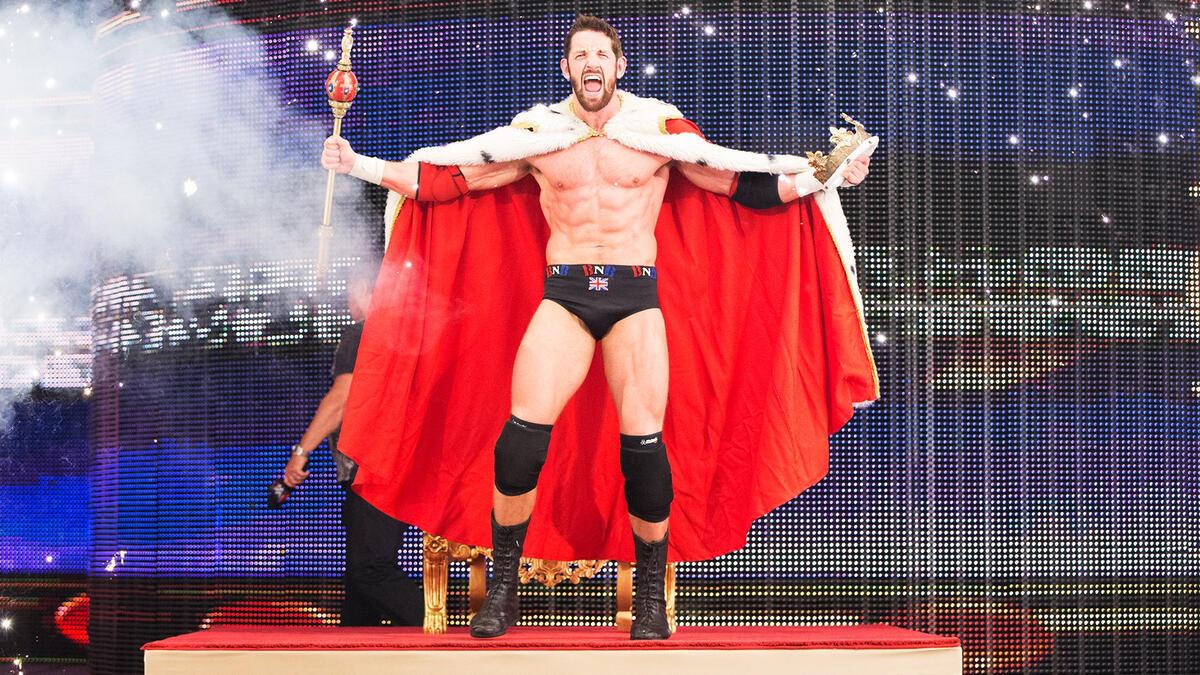 Wade Barrett wearing a red cape and holding a sceptre making his way to the ring