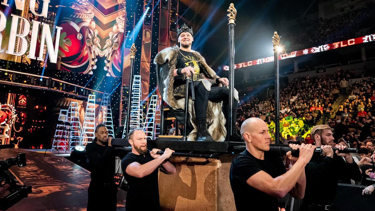 Baron Corbin sitting on a throne being carried to the ring