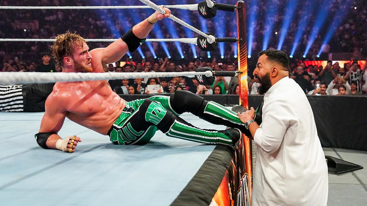 Logan Paul being pulled out of the ring by the Saudi Arabia ring announcer