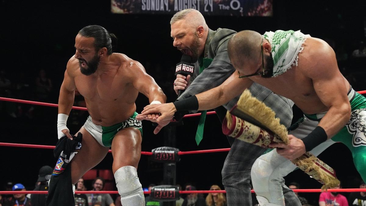 Tony Nese and Ariya Daivari touching hands at Mark Sterling introduces them