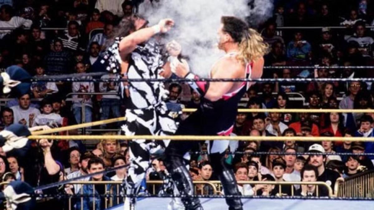 Crush blowing smoke at Randy Savage at WrestleMania X