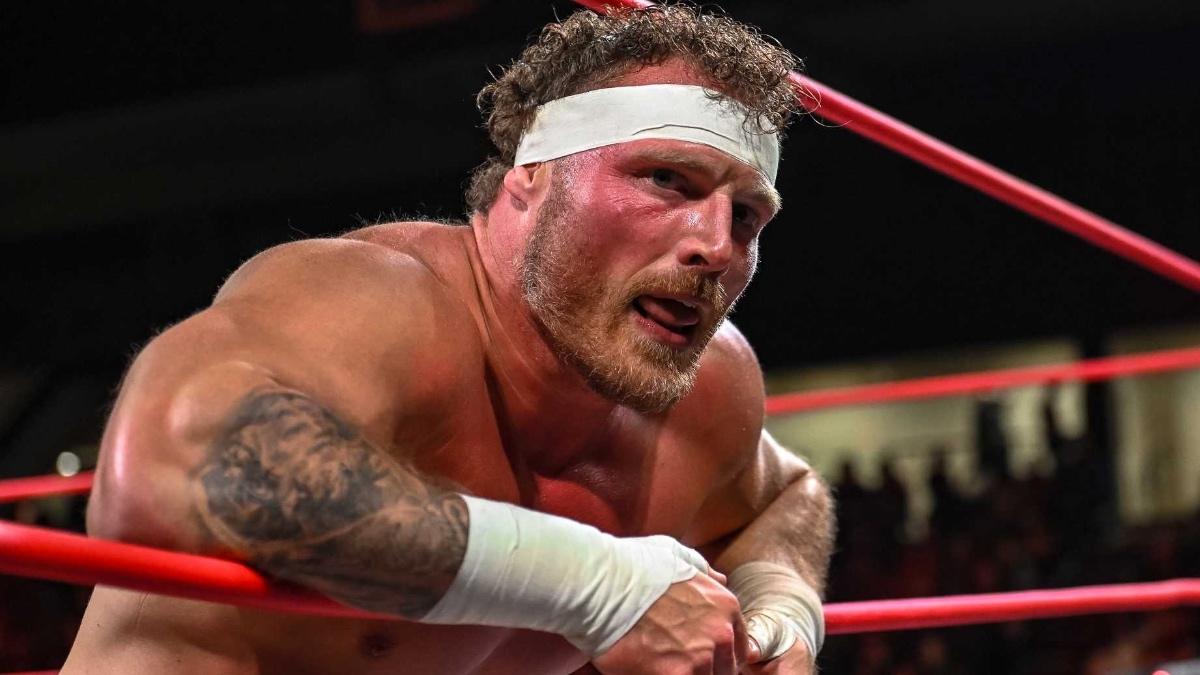 Ridge Holland in TNA wearing a white headband while lying against the ropes