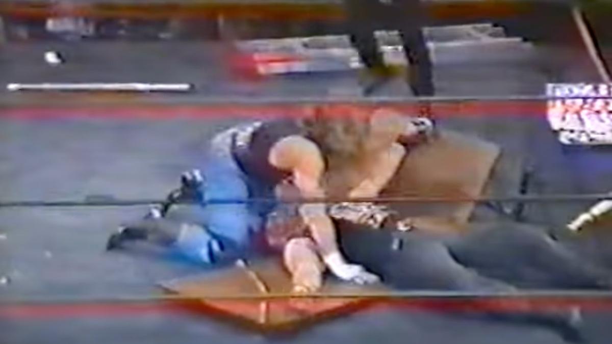 Shawn Michaels putting Venom through the table