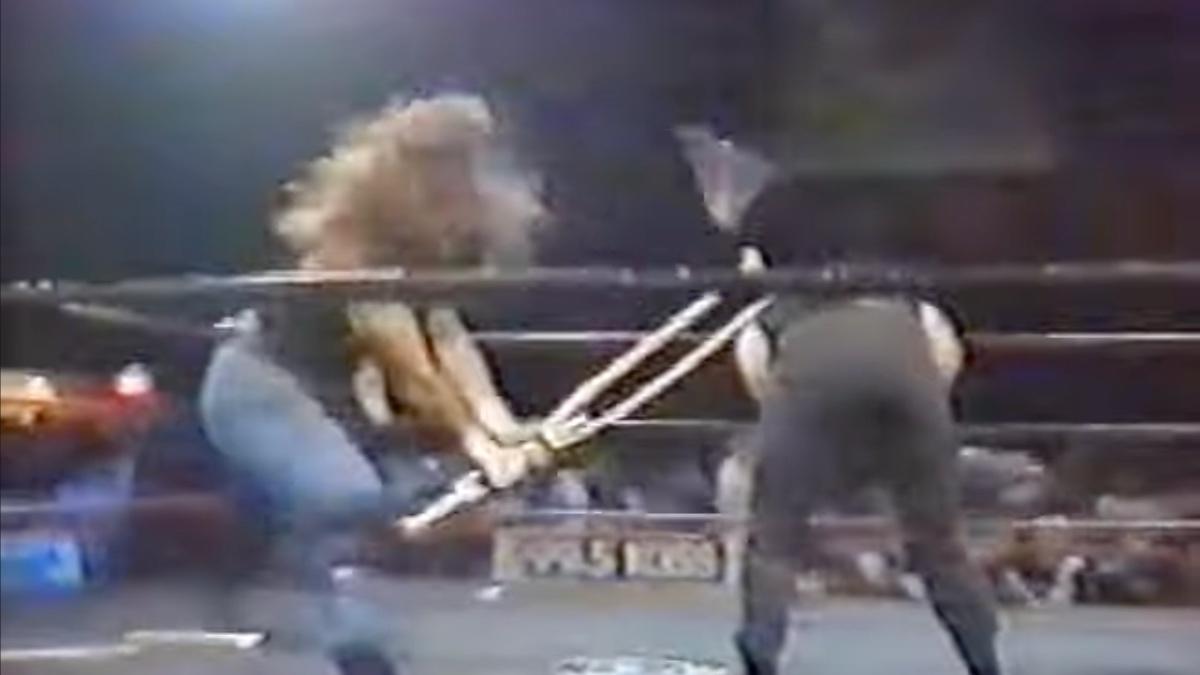 Shawn Michaels hitting Venom with a crutch