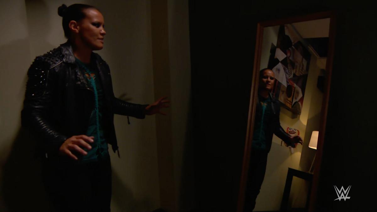 Shayna Baszler looking at Lilly the doll in a mirror