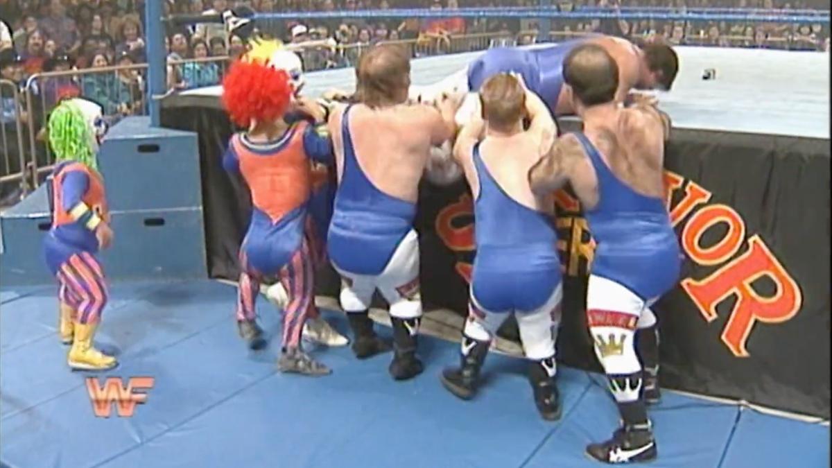 The Royal Family and Dink the clown pushing Jerry Lawler into the ring at Survivor Series 1994
