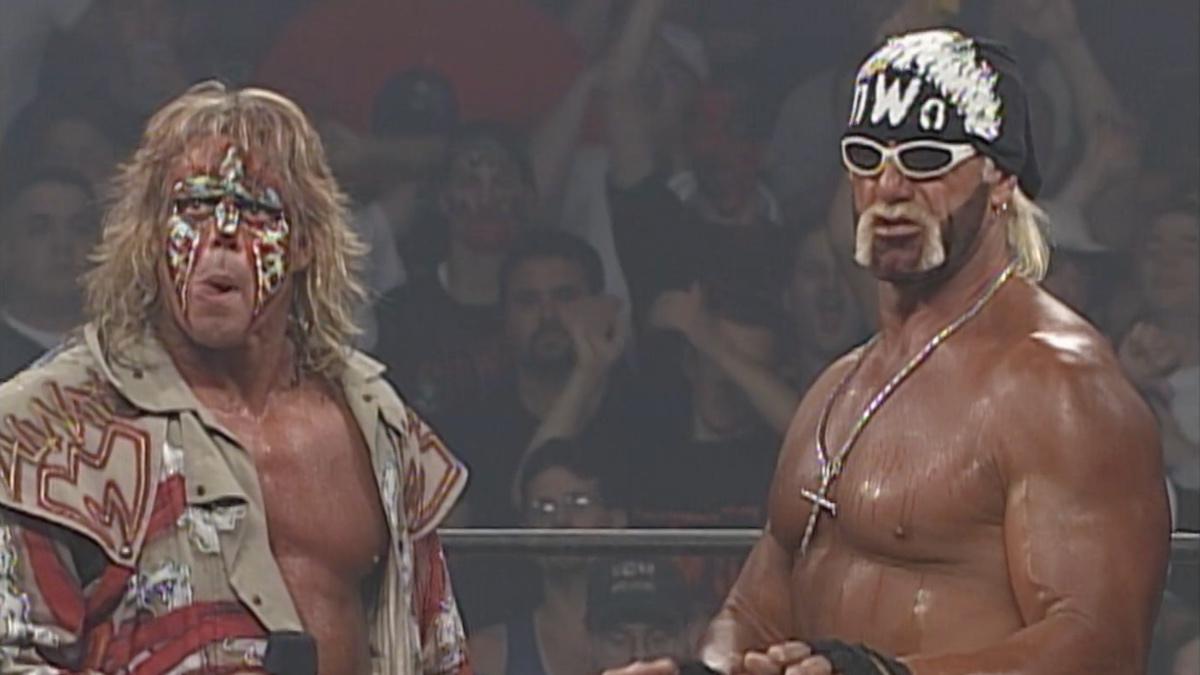 Hollywood Hogan and The Ultimate Warrior looking towards the camera during Warrior's WCW debut