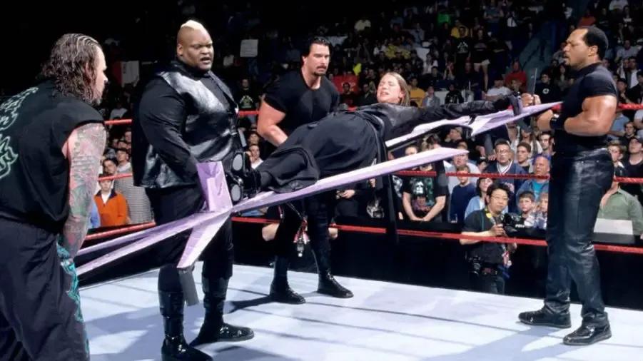 https://cultaholic.com/files/images/5e55e9d6ddf8fc05f6b4501545cb3aafe7a0da77-undertaker-stephanie-mcmahon-faarooq-bradshaw-viscera-unholy-marriage.jpg